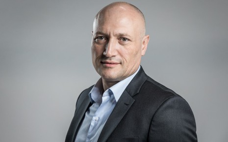 Paulo Samia, CEO do UOL Conteúdo e Serviços, posado, usando terno escuro com uma camisa azul clara