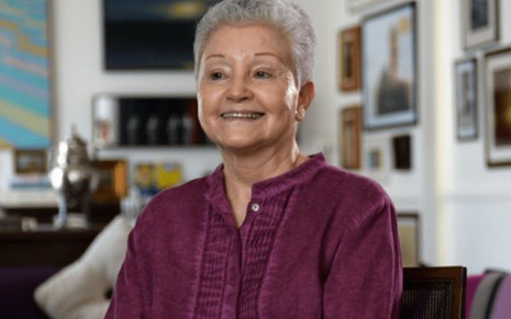 Maria Adelaide Amaral sorri e está com uma blusa roxa