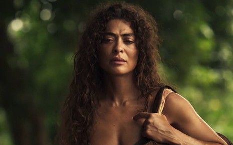 Juliana Paes segura bolsa e olha para frente com cara de séria em Pantanal