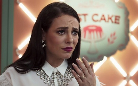 A atriz Paolla Oliveira, como a blogueira Vivi Guedes em A Dona do Pedaço, leva a mão à boca e faz cara de surpresa